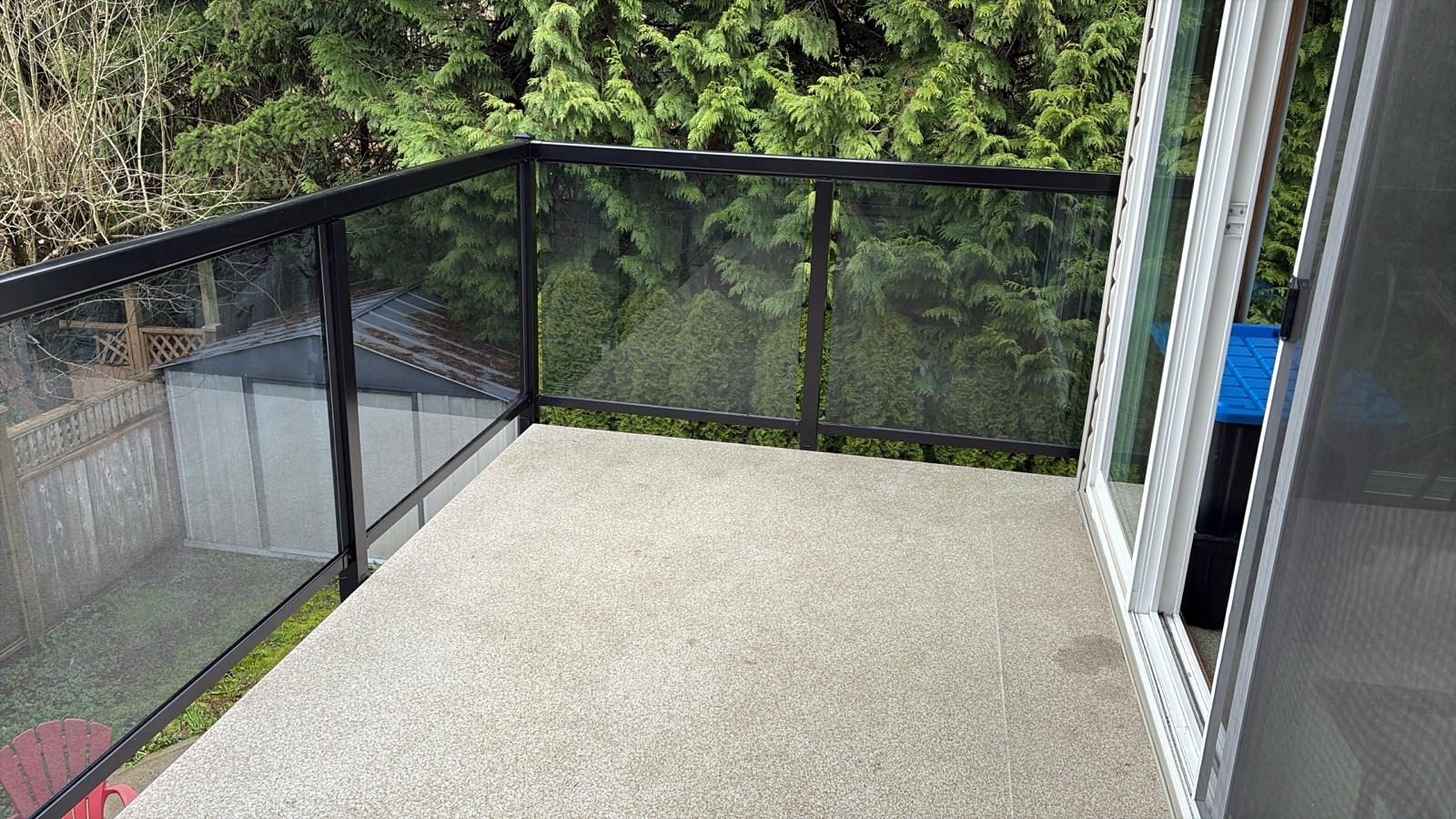Black-framed glass railing on a vinyl deck at a new Coquitlam home