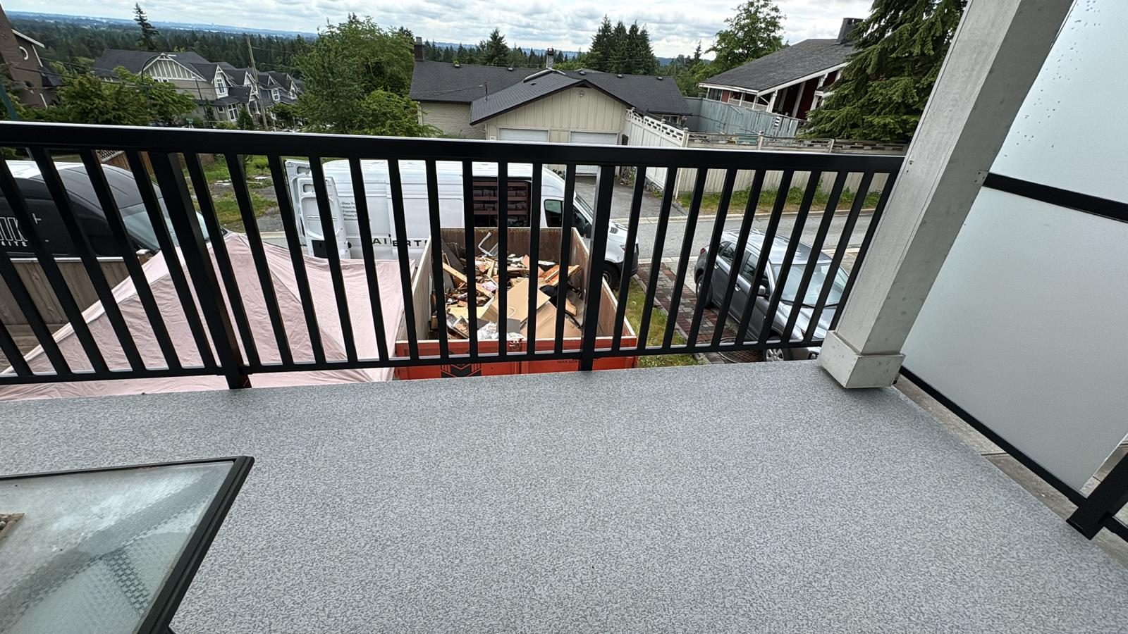 Black aluminum picket railing on a Coquitlam vinyl deck