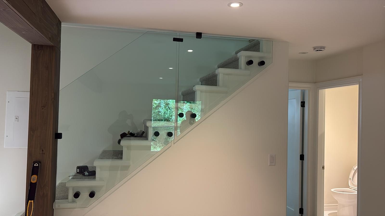 Interior frameless glass stair railing in a Coquitlam home