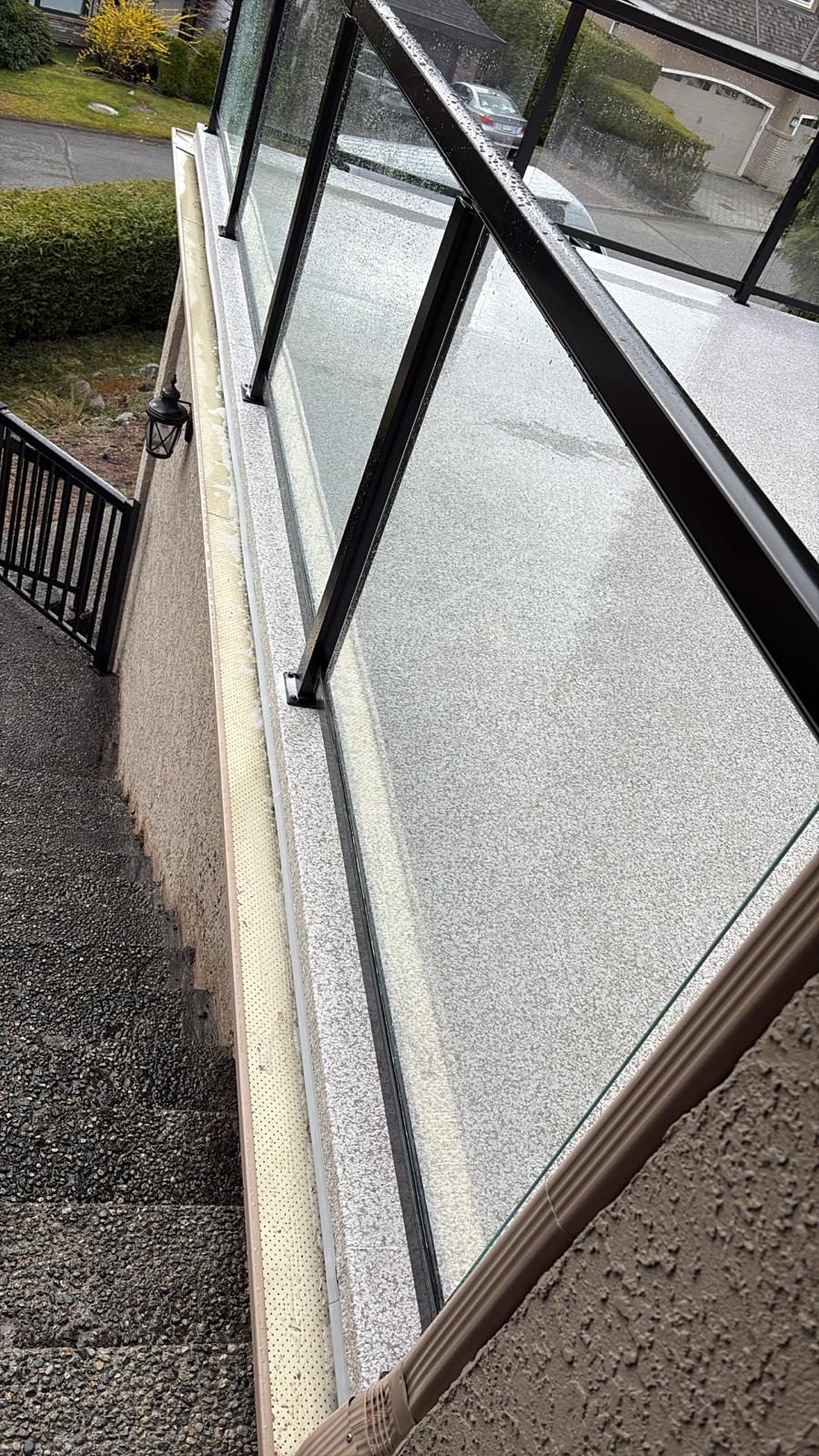 Fascia-mounted glass railing along exterior stairs in Coquitlam