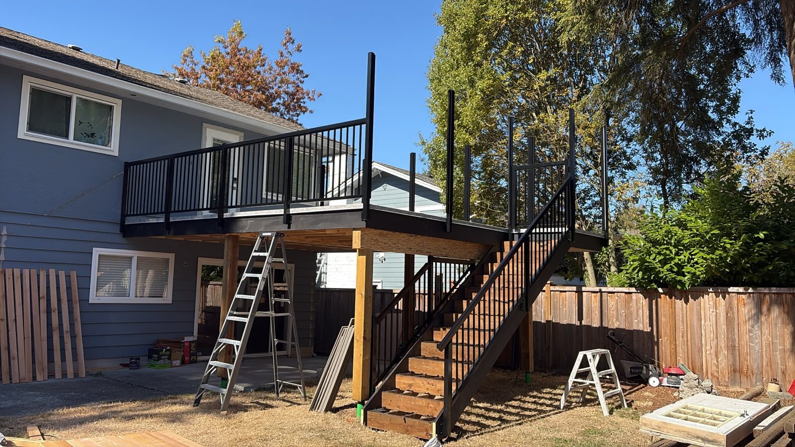 Black aluminum picket railing on a new raised deck and stairs in Delta