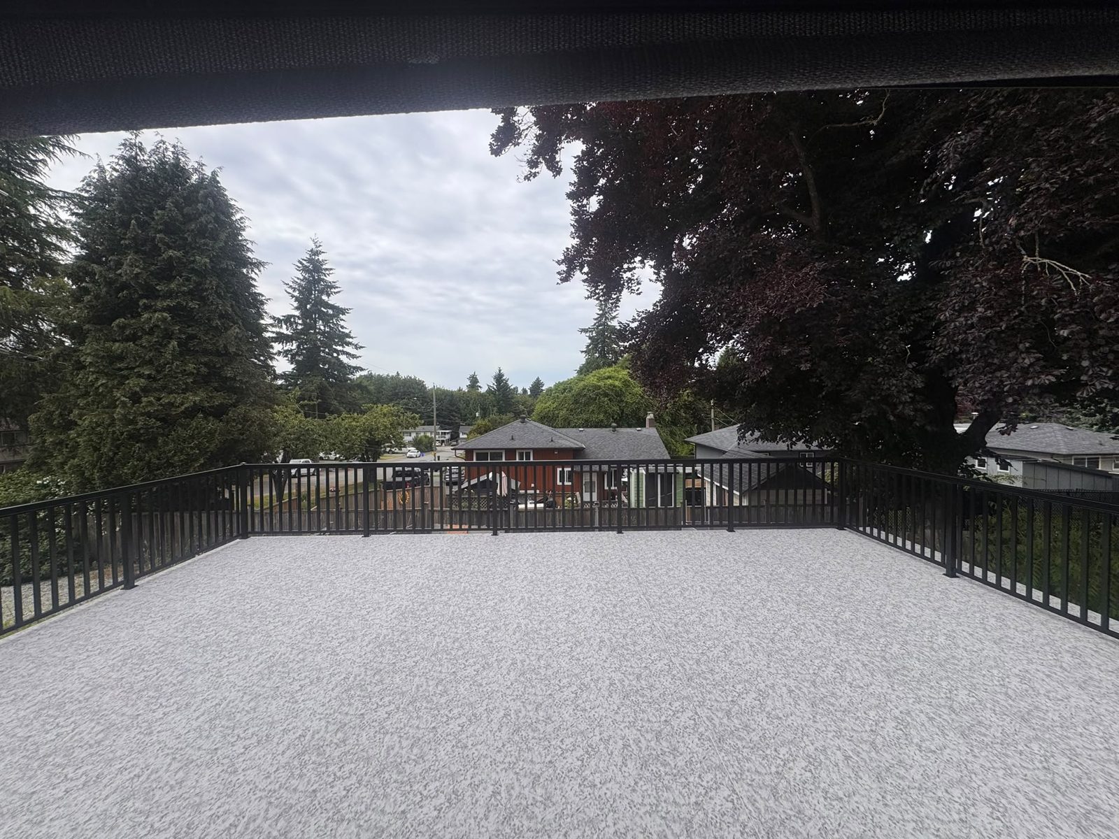 Black picket railing around a vinyl deck in Delta