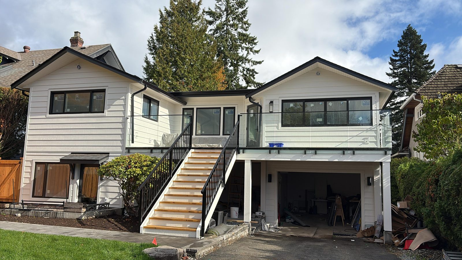 Glass deck railing with aluminum picket stair railing on a North Vancouver home