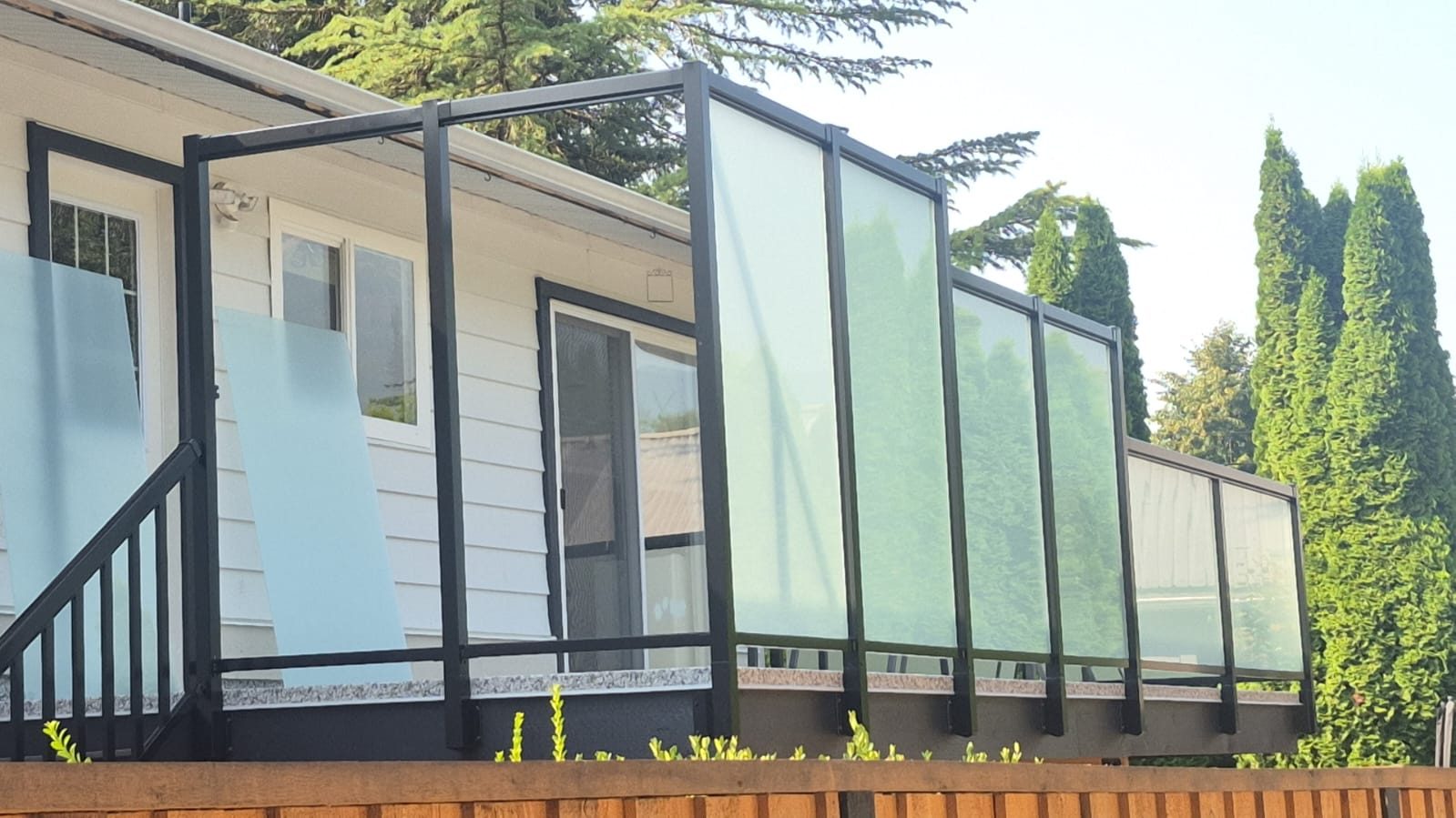 Frosted glass privacy screen panels on a North Vancouver deck