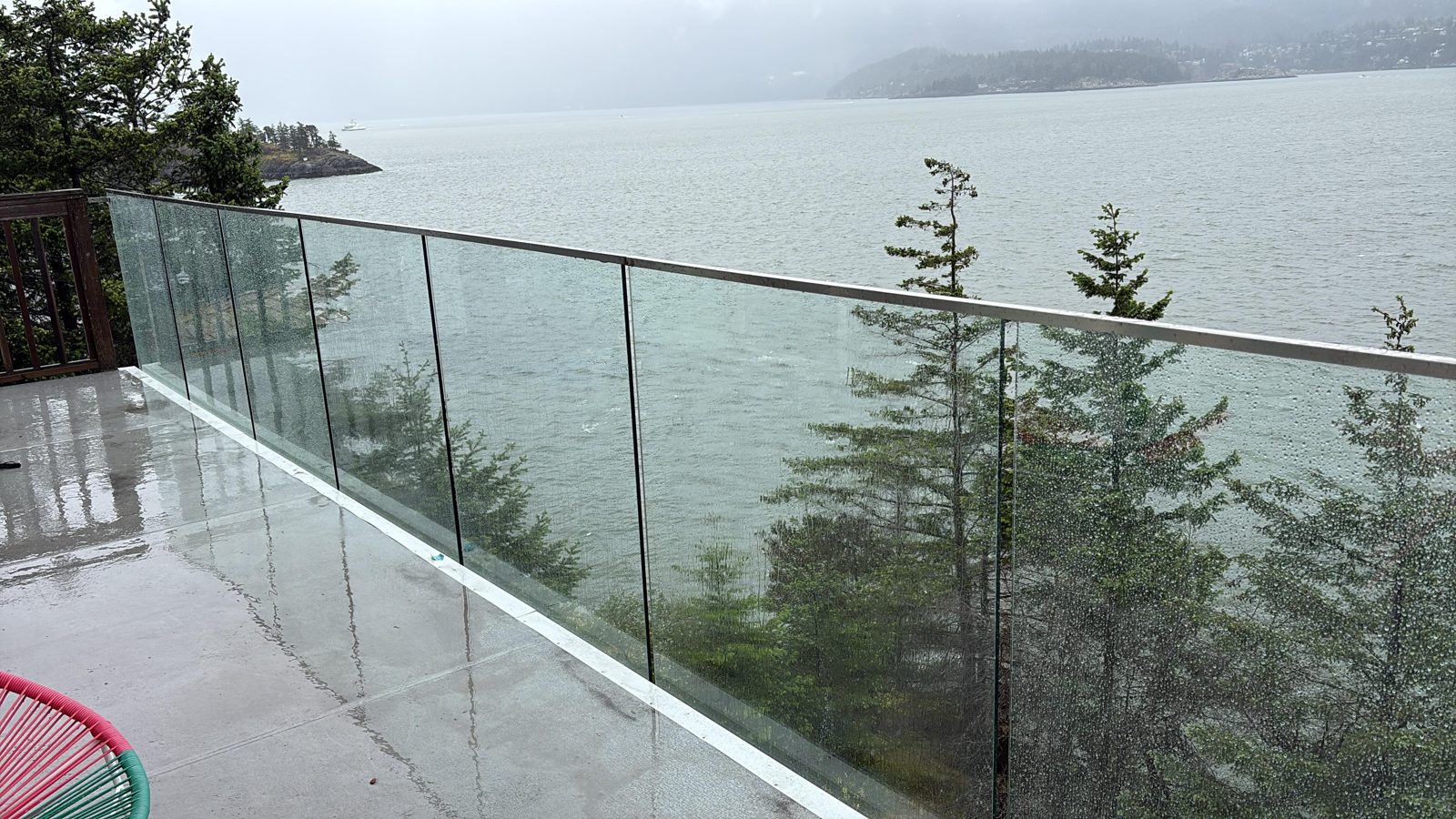Frameless glass railing on a Bowen Island deck overlooking Howe Sound