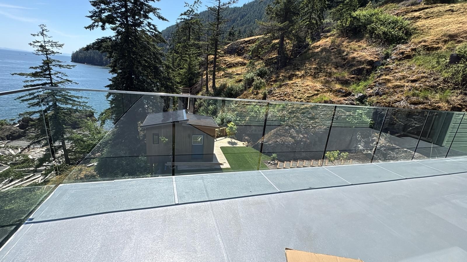 Glass deck railing with an ocean view on Bowen Island