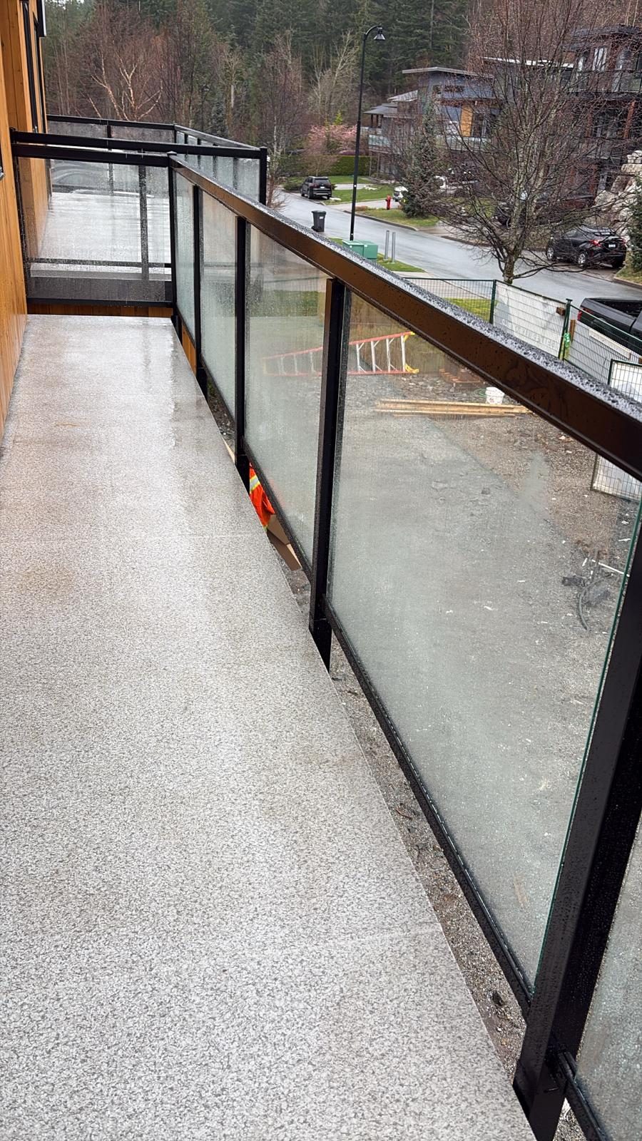 Glass railing along an exterior walkway in Squamish