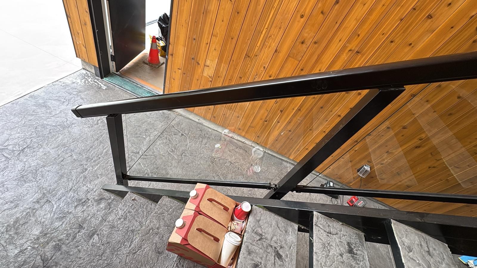 Black aluminum handrail on exterior stairs in Squamish