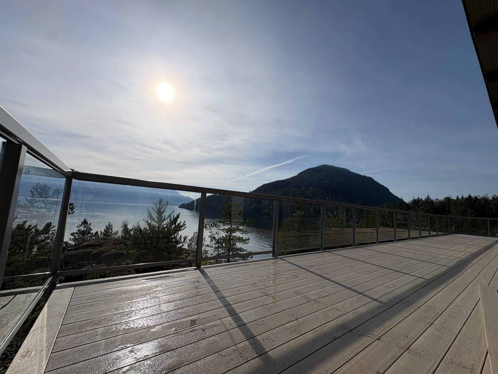 Railing on a wraparound deck overlooking Howe Sound on Gambier Island