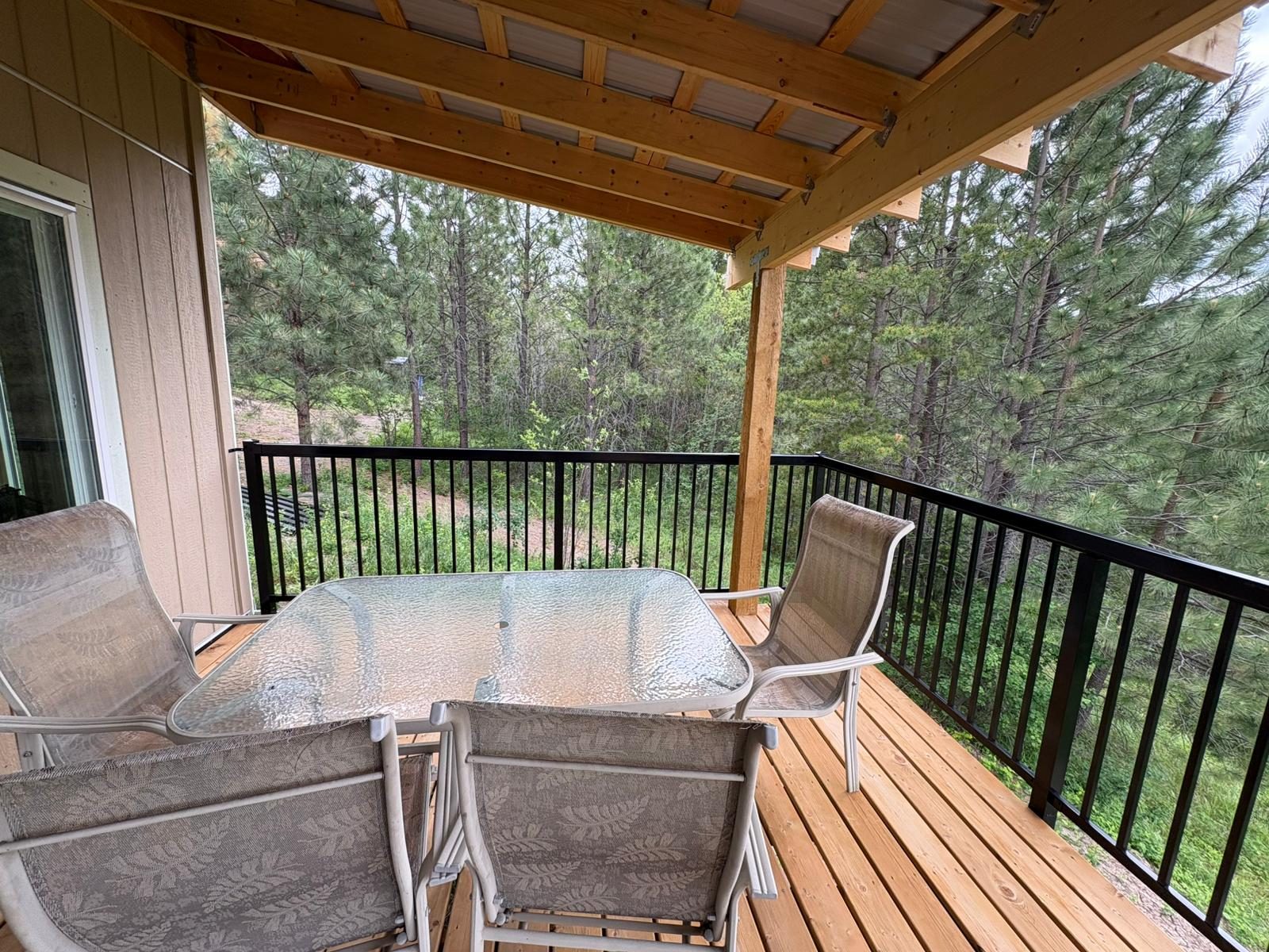 Black aluminum picket railing on a covered deck in Merritt