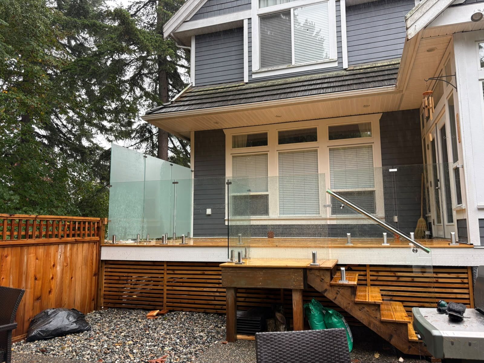 Frameless frosted glass deck railing and glass stair railing on a cedar deck in South Surrey