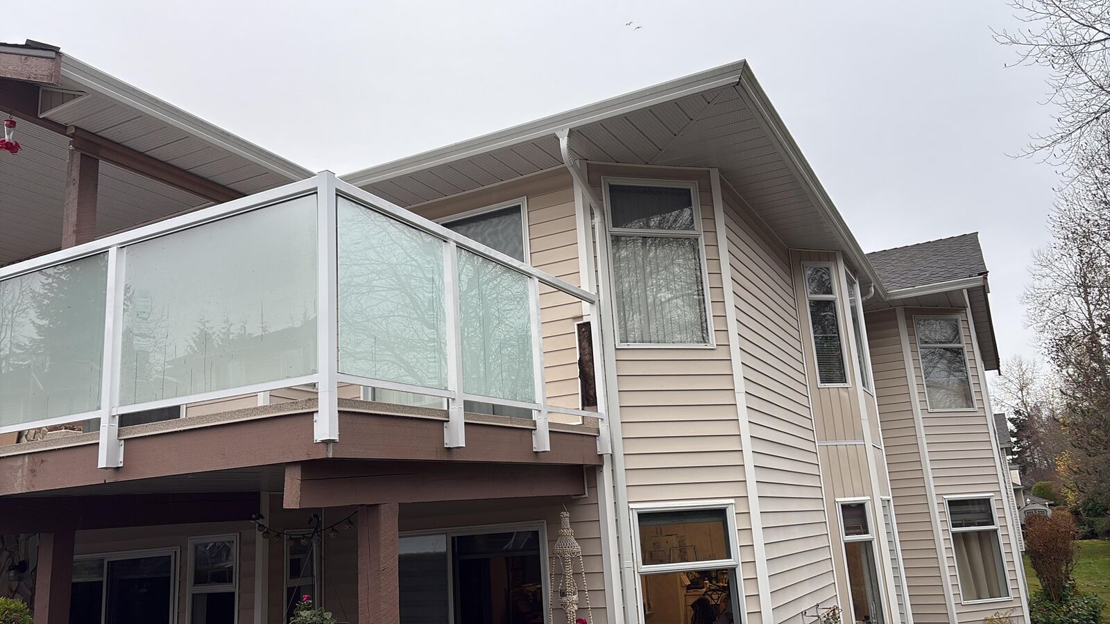 White-framed frosted glass deck railing on a Newton home in Surrey