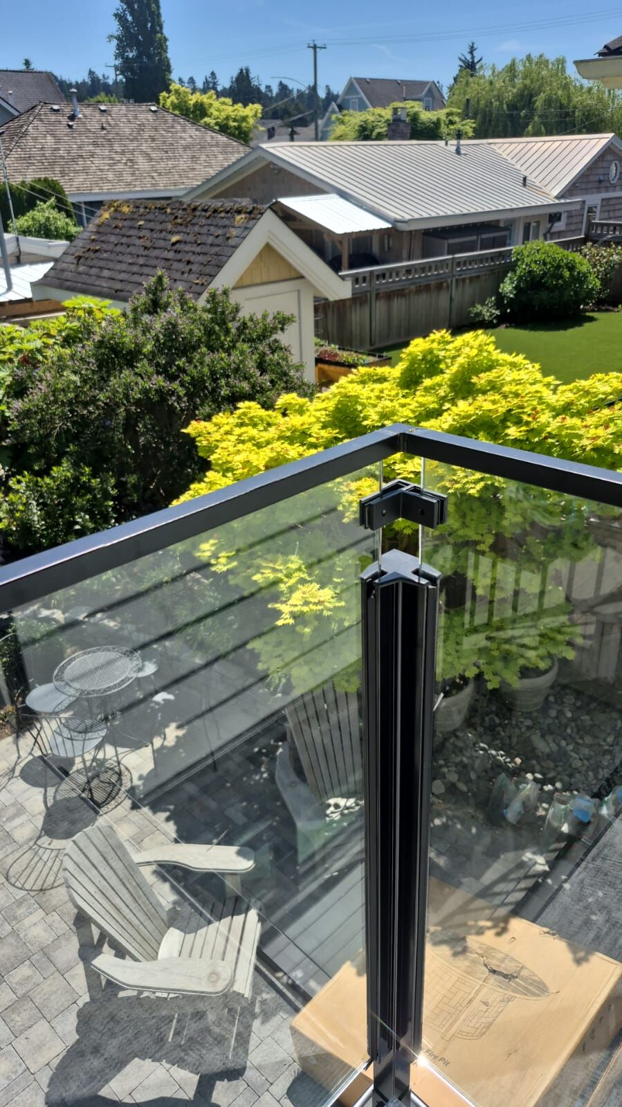 Glass balcony railing with black aluminum posts on a new home in Crescent Beach, South Surrey